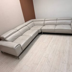 Abbyson Quinton gray top-grain leather sectional with adjustable headrests in living room